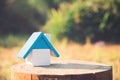 A house model on wooden with blur green nature Royalty Free Stock Photo