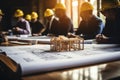 House models sit on top of several different architects drawings and floor plan Royalty Free Stock Photo