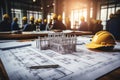 House models sit on top of several different architects drawings and floor plan Royalty Free Stock Photo