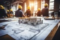 House models sit on top of several different architects drawings and floor plan Royalty Free Stock Photo