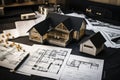 House models sit on top of several different architects drawings and floor plan Royalty Free Stock Photo