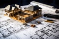 House models sit on top of several different architects drawings and floor plan Royalty Free Stock Photo