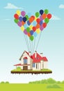 House with multicolored balloons in form of heart flying in sky over ground