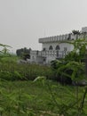 A house near the fields and moter pump in fielfs and.fields in crops.