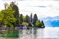 House near lake Thun and travek ship with view of Bernese Alps mountain Berne, Switzerland