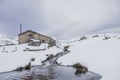 House near a snowy river