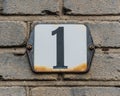 House Number 1 Black number on white plate Royalty Free Stock Photo