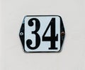 House Number 34 Black number on white plate Royalty Free Stock Photo