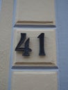 House number 41, black numbers on a cream-colored wall Royalty Free Stock Photo