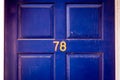 House number 78 on a bright blue wooden front door