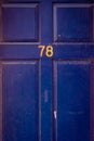 House number 78 on a bright blue wooden front door