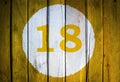 House number or calendar date in white circle on yellow toned Royalty Free Stock Photo