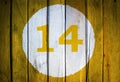 House number or calendar date in white circle on yellow toned Royalty Free Stock Photo