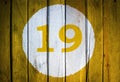 House number or calendar date in white circle on yellow toned