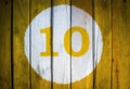House number or calendar date in white circle on yellow toned Royalty Free Stock Photo