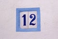 House number on ceramic tiles on white wall Royalty Free Stock Photo