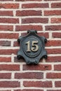 House number made of metal on a brick wall Royalty Free Stock Photo