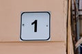 House number one. Black lettering on a white metal plate Royalty Free Stock Photo