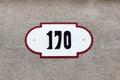 House number 170 one hundred and seventy. Black lettering on a white fashioned metal plate