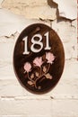 House number 181 on an oval plaque with three roses Royalty Free Stock Photo
