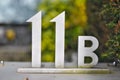 A house number plaque, showing the number eleven B 11 b