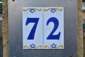 A house number plaque, showing the number seveny two in tiles 72 Royalty Free Stock Photo