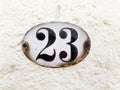 23 - house number plaque twenty-three on wall