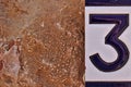 House number sign number three on a wall Royalty Free Stock Photo