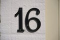 House Number 16 sign on wall