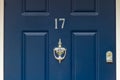 House number 17 in silver on blue