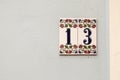 House number thirteen, sign at wall Royalty Free Stock Photo