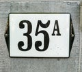 House Number 35A thirty five A, black numbers on a white plate w Royalty Free Stock Photo