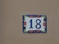 House number 18 on the tiles on the orange wall Royalty Free Stock Photo