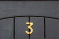House number 3 under a semicircle