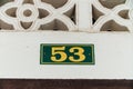 House number 53, yellow. Plate with a frame on self-tapping screws