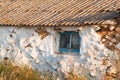 House old ruined abandoned askew one - storey with window, cracked plaster