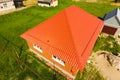 House with an orange roof made of metal. Metallic profile painted corrugated on the roof Royalty Free Stock Photo