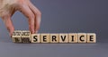 In-house or outsourced service symbol. Businessman turns cubes and changes words In-house service to Outsourced service. Grey