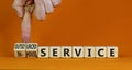 In-house or outsourced service symbol. Businessman turns cubes and changes words In-house service to Outsourced service. Orange