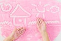 House painted children`s hands on the decorative sand. Royalty Free Stock Photo