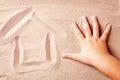 House is painted on sand by the hand of child. Concept House by the sea Royalty Free Stock Photo