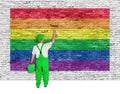 House painter covers brick wall with rainbow flag Royalty Free Stock Photo