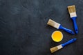 House-painter desk with set of building implements, pain, brushes dark desk background top view mock up