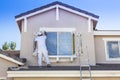 House Painter Painting the Trim And Shutters of Home