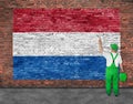 House painter paints flag of Hetherlands on brick wall Royalty Free Stock Photo