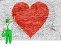 House painter paints symbol of broken love on brick wall Royalty Free Stock Photo