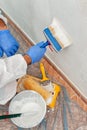 House painter at work painting a wall with a brush Royalty Free Stock Photo