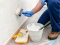 House painter at work painting a wall with a brush Royalty Free Stock Photo