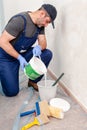 House painter at work prepares white paint Royalty Free Stock Photo