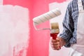 House painter worker with work tools. Construction site Royalty Free Stock Photo